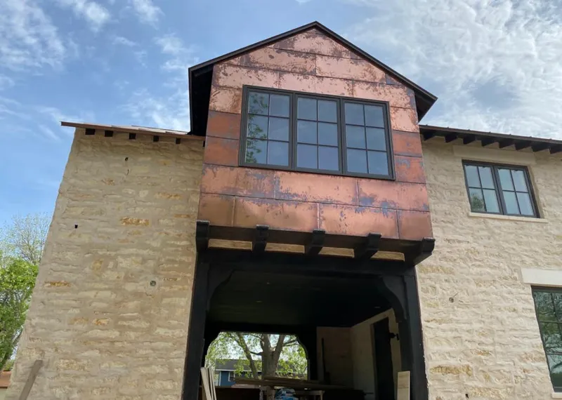 Copper metal panel facade on a stone building for Metal Roof Coating in Merrifield